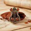 Изысканная брошь "Лира" из латуни с натуральным янтарем. Изысканная брошь "Лира" из латуни с натуральным янтарем.